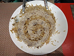 Mutton biriyani in a white plate.