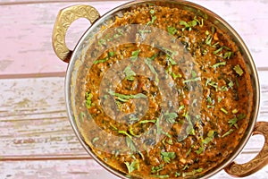 Mutton Palak Gosht Korma served in karahi isolated on table closeup top view of indian spices food