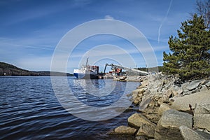 Mv Falknes load gravel at Bakke harbor