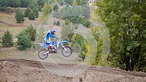 MX moto cross racing - Girl Bike Rider rides on a dirt motorcycle - extreme jump