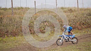 MX moto Girl Biker shows acrobatic at cross racing - rider on a dirt motorcycle