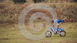 MX moto woman Biker shows acrobatic at cross racing - rider on a dirt motorcycle