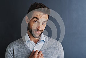 My ambition is to succeed. Portrait of a handsome young businessman posing against a dark background.