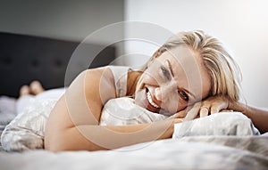 My bed is my favorite place. Shot of a mature woman lying in bed.