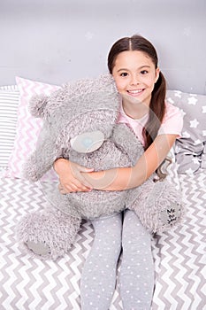 My best friend. Favorite toy. Girl child hug teddy bear in her bedroom. Pleasant time in cozy bedroom. Girl kid long