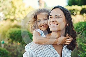 My daughter is my greatest accomplishment. Shot of a young woman giving her daughter a piggyback ride.