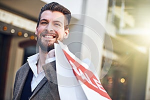 My favorite shop had a sale. a young man holding a shopping bag.