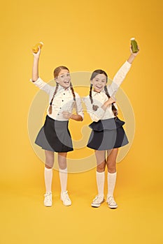 My favourite food. happy classmates in school uniform. back to school. little girls hold healthy juice or yoghurt. lunch