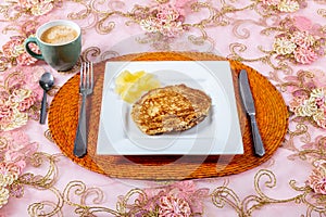 My first pancake accompanied by pineapple on a white square plate