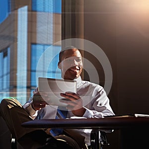 This is my go-to technology tool. a young man contemplating while using his digital tablet.