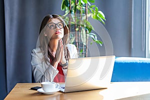 My God, please help me or forgive me. Portrait of worry stylish brunette young woman in glasses sitting, looking up, pleading,