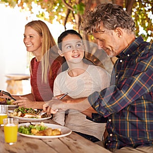 My granddad is the greatest. A view of a family preparing to eat lunch together outdoors.