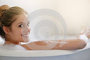 This is my happy place. Portrait of a beautiful young woman relaxing in the bathtub.