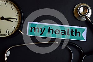 My Health on the print paper with Healthcare Concept Inspiration. alarm clock, Black stethoscope.