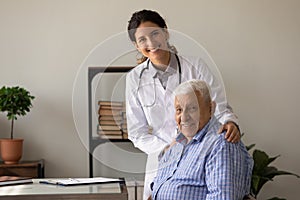 Portrait of smiling doc and retired patient in doctor office photo