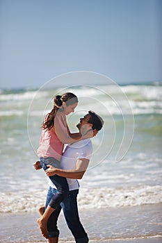 My heart is perfect, because youre inside. a loving young couple being playful on the beach.