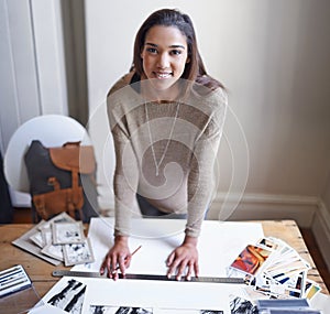 My hobby makes me happy. A young woman working on her portfolio at home.
