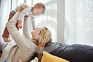 My life is filled with joy, happiness, wonder and love. a happy young mother playing with her baby boy at home.