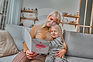 My loving grandmother! Grandmother reads a postcard given to her by her granddaughter. The concept of family, love, care, respect