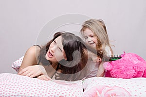 My mother is very sick. Daughter combing her hair