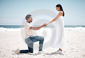 My always, my forever. Shot of a young man proposing to his girlfriend at the beach.