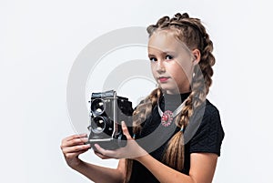 My new camera. cheerful girl with retro look isolated on white. kid vintage fashion. child take photo on retro camera