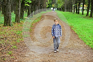 My perfect weekend is going for a walk. Small boy on pleasant foot walk in park. Small wanderer. Little boy walk along