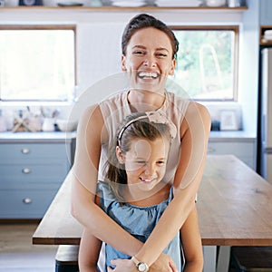 My princess makes me so happy. an affectionate young mother looking cheerful while holding her daughter in their kitchen