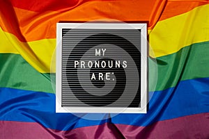 MY PRONOUNS ARE text Neo pronouns concept on Rainbow flag background gender pronouns. Non-binary people rights