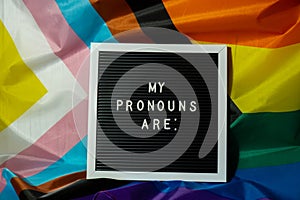 MY PRONOUNS ARE text Neo pronouns concept on Rainbow flag background gender pronouns. Non-binary people rights