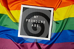 MY PRONOUNS ARE text Neo pronouns concept on Rainbow flag background gender pronouns. Non-binary people rights