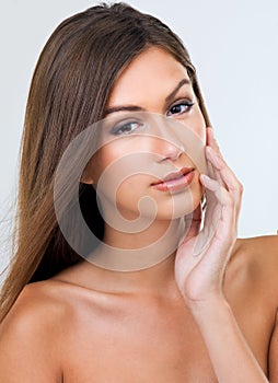 My skin is so soft. Cropped studio portrait of a beautiful young woman touching her face.