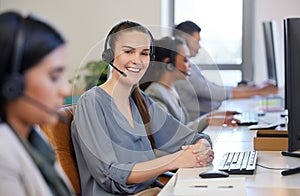 My team and I are making the most sales today. Portrait of a young call centre agent working alongside her colleagues in