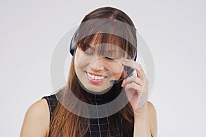 My word is my worth. Studio shot of an attractive young female customer service representative wearing a headset against
