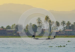 Myanmar fishman riding canoe boat photo