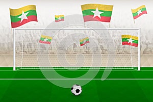Myanmar football team fans with flags of Myanmar cheering on stadium, penalty kick concept in a soccer match
