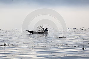 Myanmar, man fishing on Inle lake