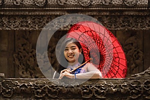 Myanmar woman in Burmese traditional dress at Shwenandaw Kyang monastery in Mandalay Myanmar