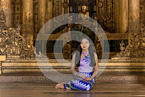 Myanmar woman in Burmese traditional dress at Shwenandaw Kyang monastery in Mandalay Myanmar