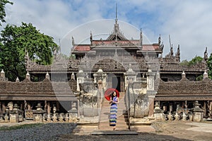 Myanmar woman in Burmese traditional dress at Shwenandaw Kyang monastery in Mandalay Myanmar