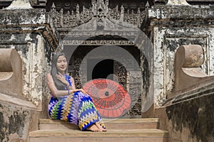 Myanmar woman in Burmese traditional dress at Shwenandaw Kyang monastery in Mandalay Myanmar