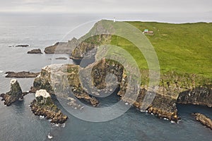 Mykines lighthouse and cliffs on Faroe islands from helicopter