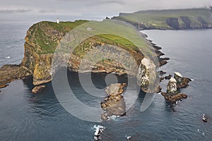 Mykines lighthouse and cliffs on Faroe islands from helicopter