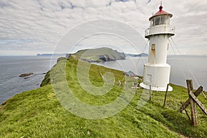 Mykines lighthouse and cliffs on Faroe islands. Hiking landmark