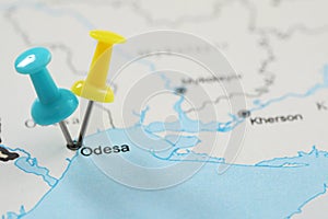 MYKOLAIV, UKRAINE - NOVEMBER 09, 2020: Odesa city marked with push pins on contour map of Ukraine, closeup