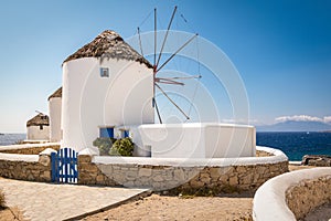 Mykonos, Greece. Scenic view of famous whitewashed windmills in town at the coast on a beautiful summer vacation day.