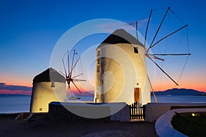 Mykonos, Greece. Traditional windmills. The symbol of Mykonos during  sunset. Landscape during sunset. Sea shore and beach.