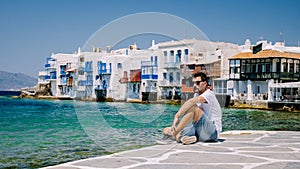 Mykonos Greece, Young man at the Streets of old town Mikonos during vacation in Greece, Little Venice Mykonos Greece