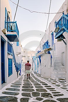 Mykonos Greece, Young man at the Streets of old town Mikonos during vacation in Greece, Little Venice Mykonos Greece