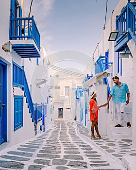 Mykonos Greece, Young man and woman in dress at the Streets of old town Mikonos during vacation in Greece, Little Venice